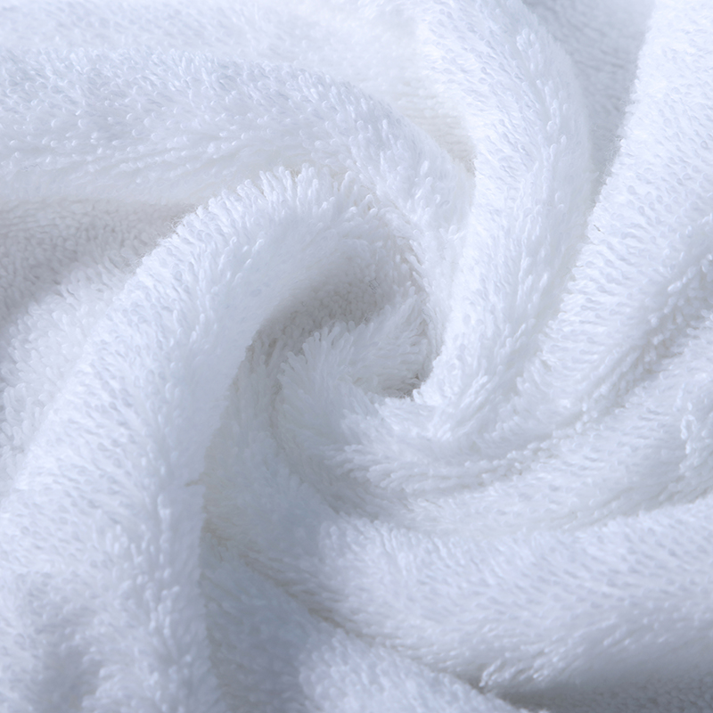 White soft hotel towels folded in a luxury bathroom